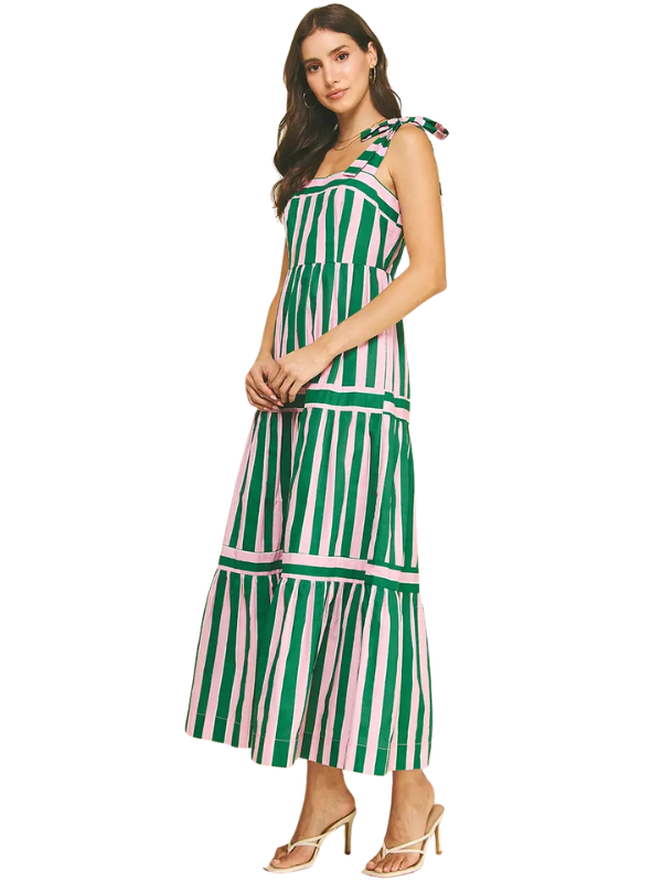 Woman wearing a green and white striped dress on a white background