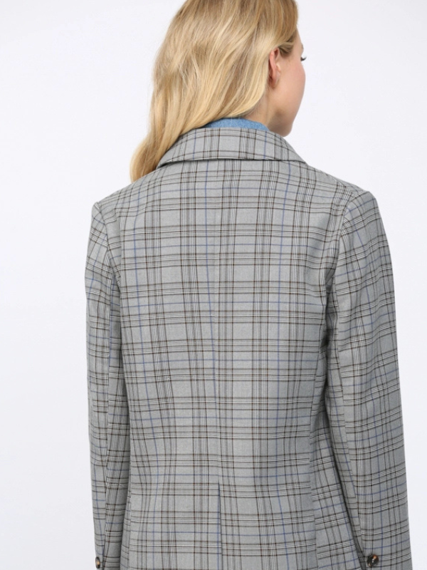 Gray checkered blazer worn by a person on a white background