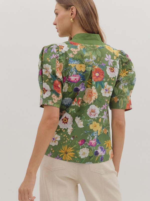 Woman wearing a floral blouse with a white background