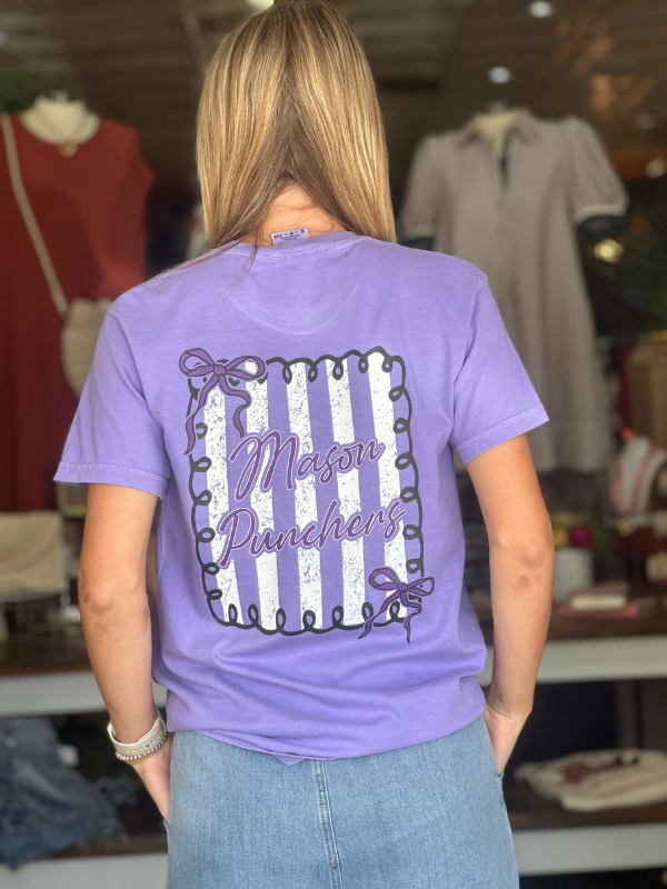 Person wearing a purple t-shirt with 'Mason Punchers' design in a store setting