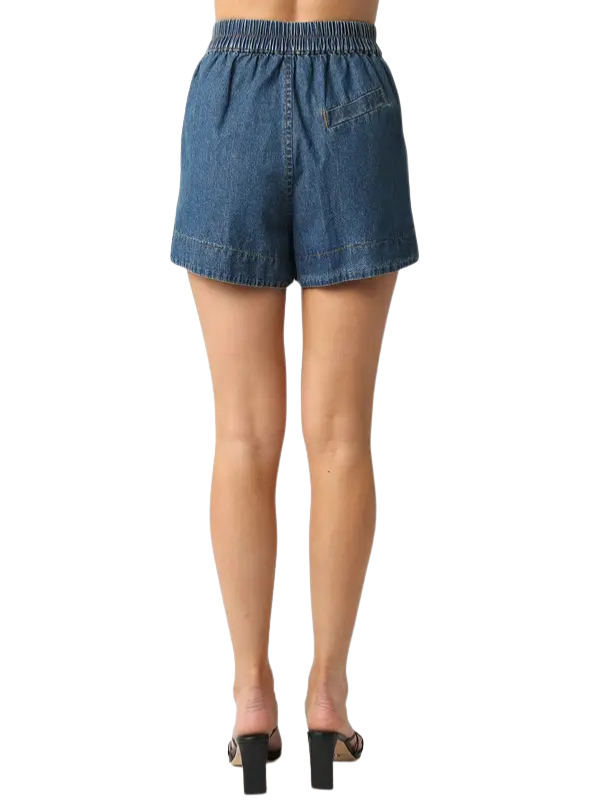 Denim shorts worn by a person on a white background