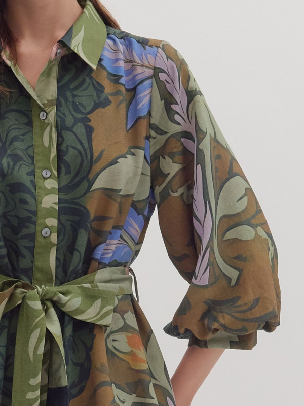 Floral patterned shirt with a tie waist on a plain background