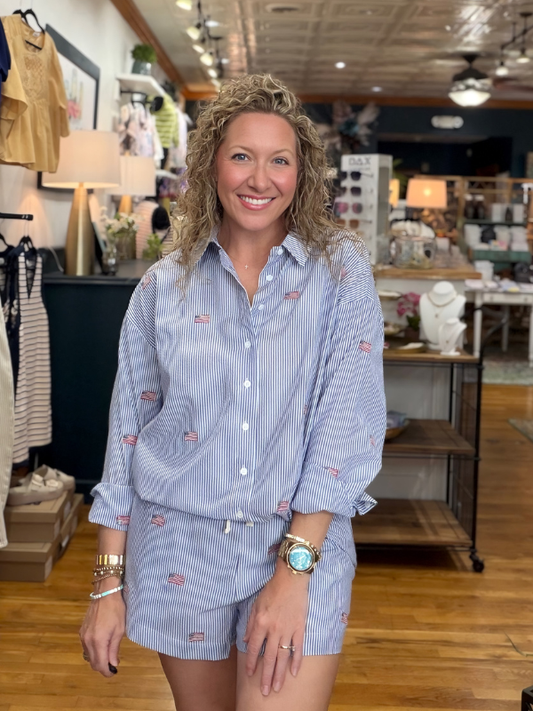Woman wearing a blue striped outfit in a store setting