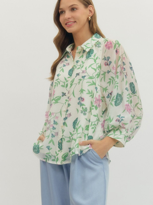 Woman wearing a floral blouse with a plain background