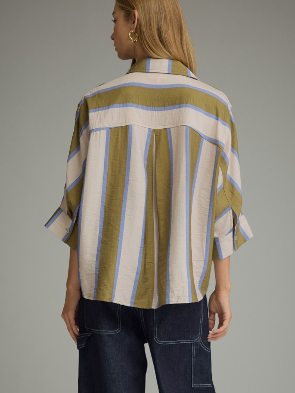 woman wearing an olive and blue striped button up top