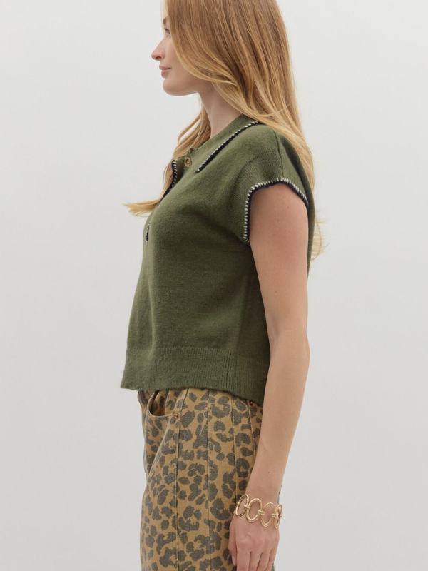 Woman wearing a green top and leopard print pants on a white background
