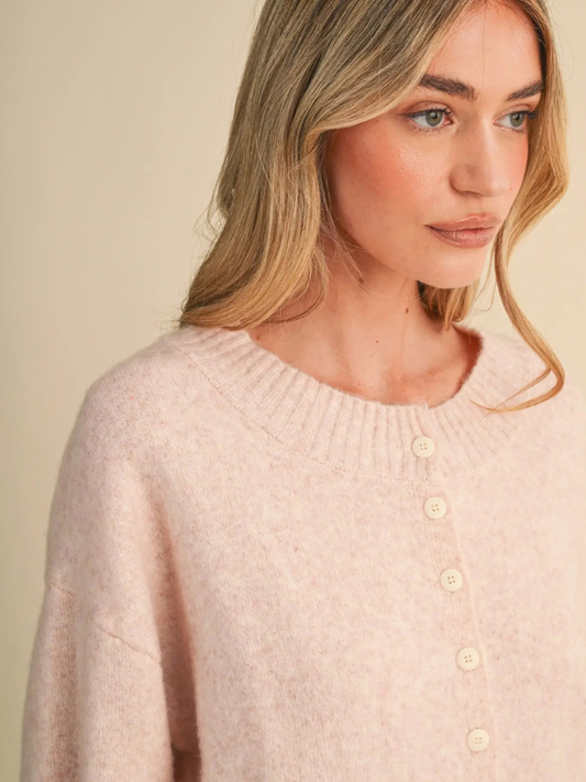 woman wearing a pink button sweater