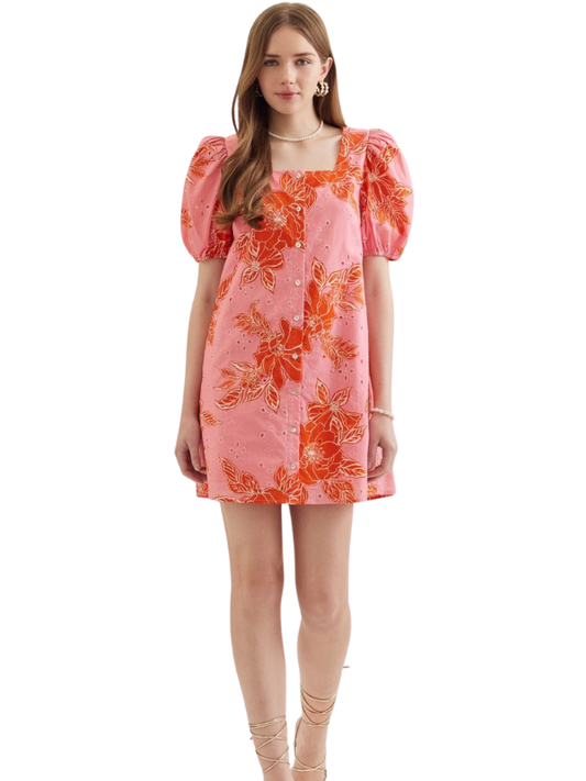 Woman wearing a pink floral dress on a white background
