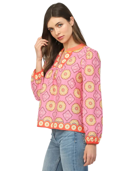 Woman wearing a pink floral patterned top on a white background