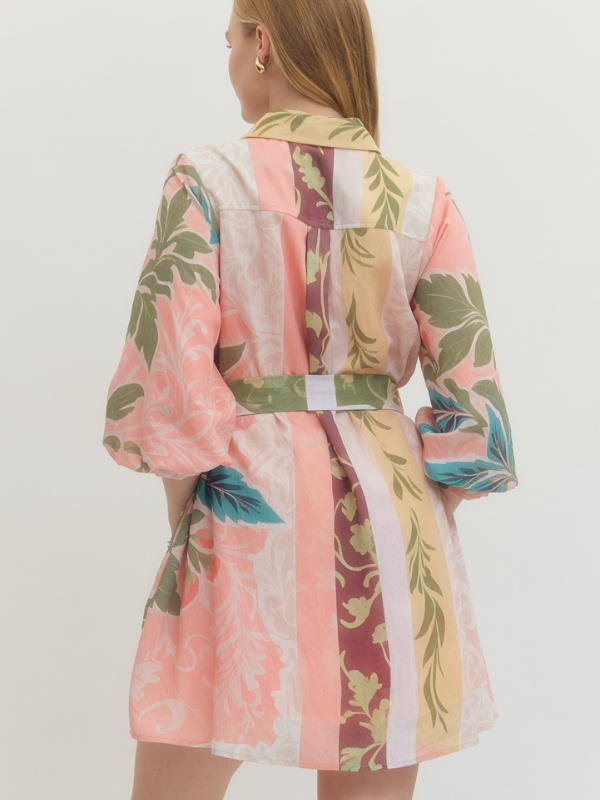 Woman wearing a colorful floral kimono-style garment on a white background
