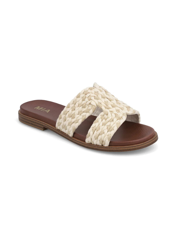 Beige woven sandal with brown straps on a white background