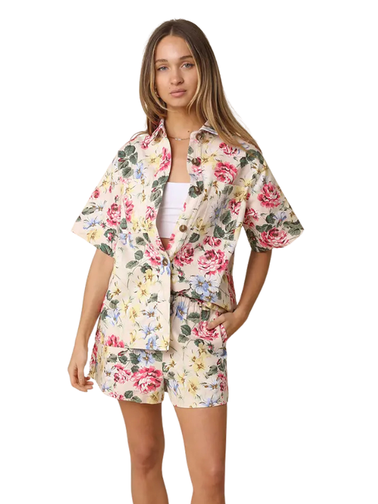 Woman wearing a floral outfit on a white background