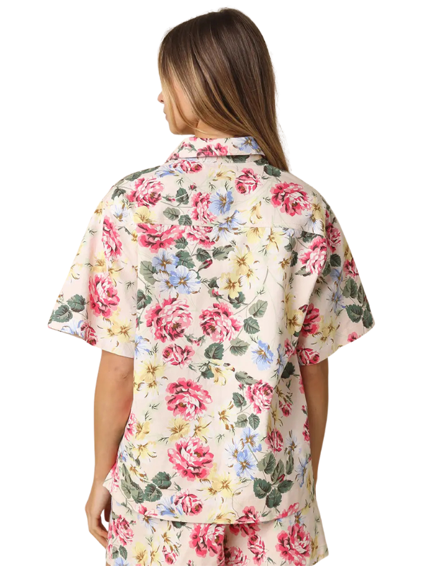 Woman wearing a floral shirt on a white background