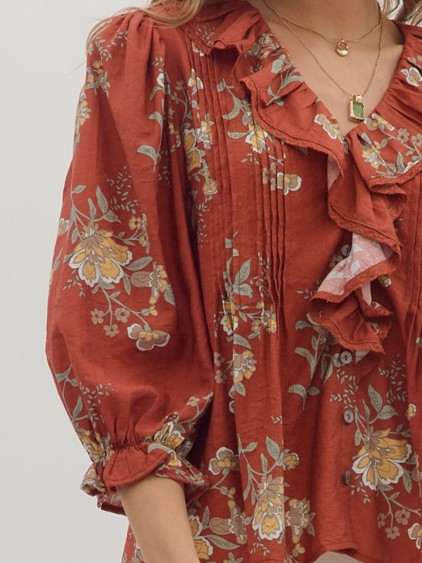 Red floral dress with ruffled sleeves on a plain background