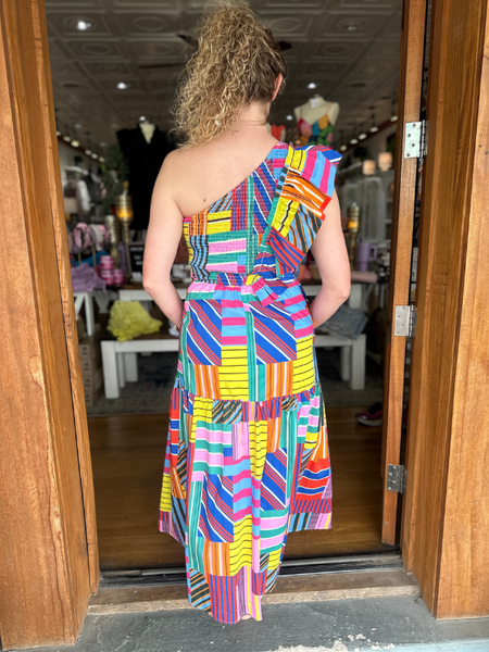Get ready to turn heads in our Red + Royal Multi Stripe Dress! With a playful one ruffle shoulder, this maxi dress is perfect for any vacation. The elastic back provides a comfortable fit, while the tiered skirt adds a fun touch.