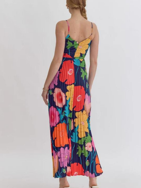 This Floral Print Maxi Dress features a vibrant, pleated design with a flattering V-neck and adjustable straps. The lightweight, non-sheer fabric is perfect for warm weather, and the zipper closure at the back adds a touch of convenience. 