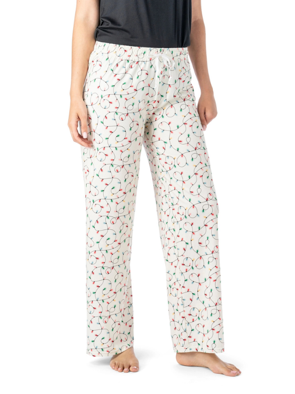 Person wearing white pajama pants with a colorful pattern on a white background