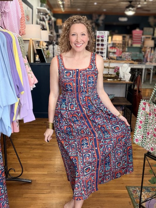 Woman wearing a patterned dress in a clothing store