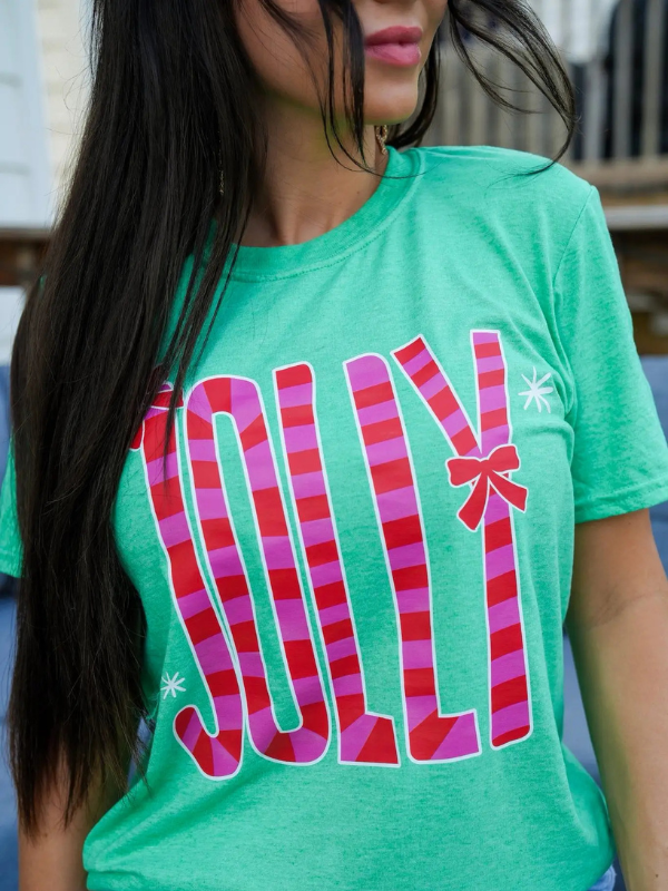 Green t-shirt with colorful 'Jolly' design worn by a person