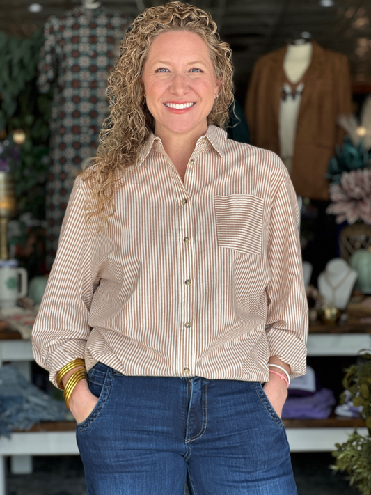 Woman wearing a striped shirt and jeans in a store setting