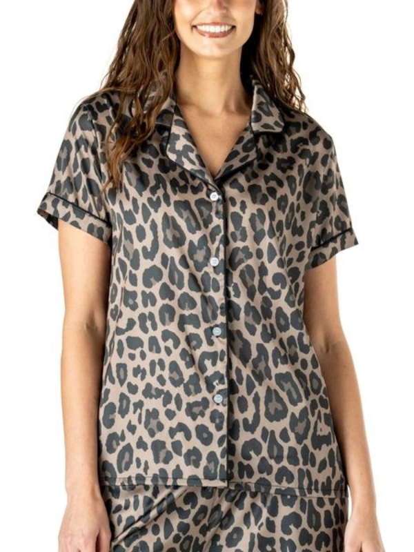 Woman wearing a leopard print pajama set on a white background