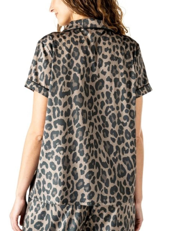 Leopard print shirt worn by a person on a white background