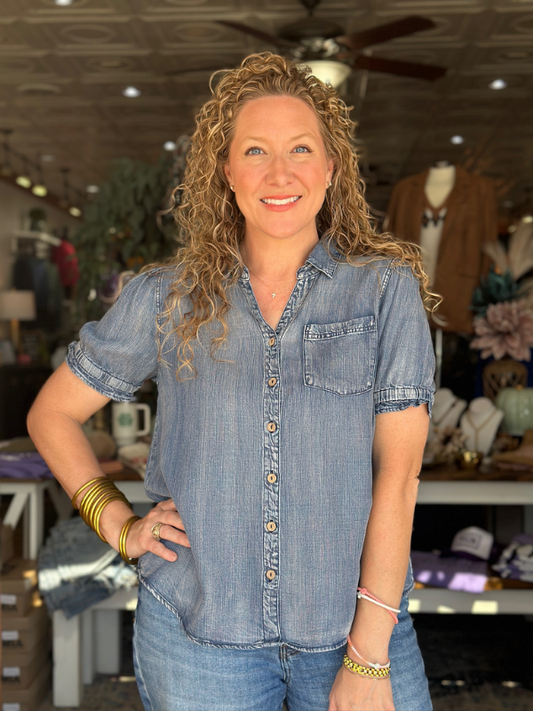 Woman wearing a denim shirt in a store setting