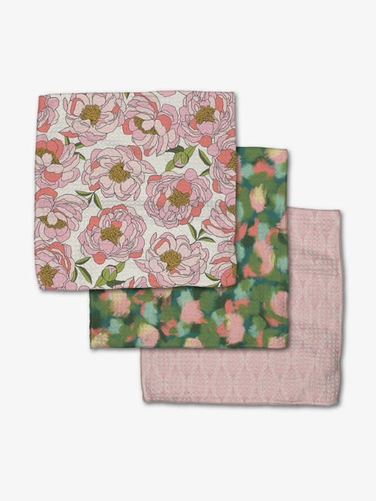 Three floral-patterned cloths stacked on a white background