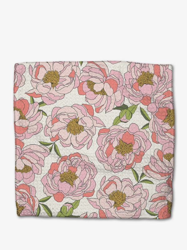 Floral patterned fabric with pink flowers and green leaves on a white background