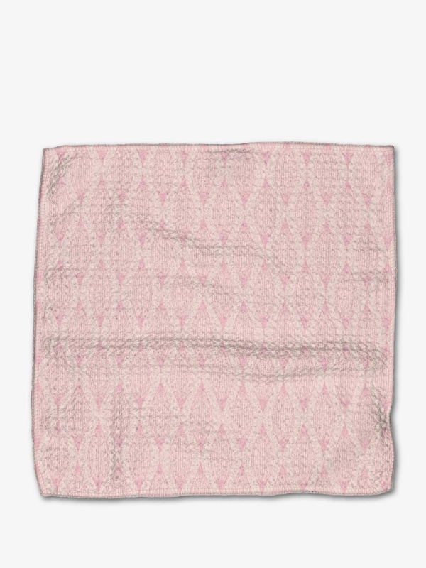Pink textured fabric square on a white background