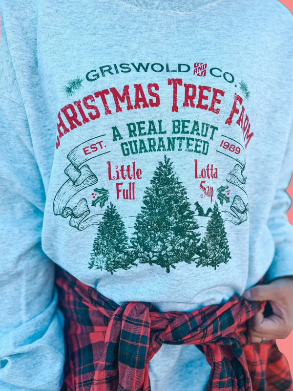 Light blue sweatshirt with Christmas tree farm graphic and text