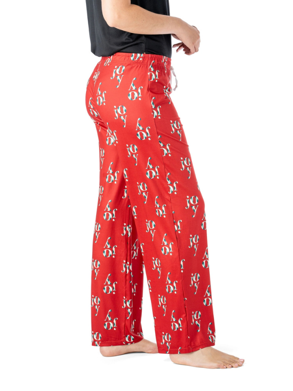 Red pajama pants with a pattern worn by a person on a white background