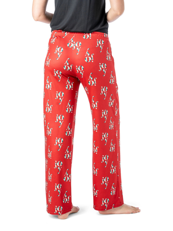 Red pajama pants with a pattern worn by a person on a white background