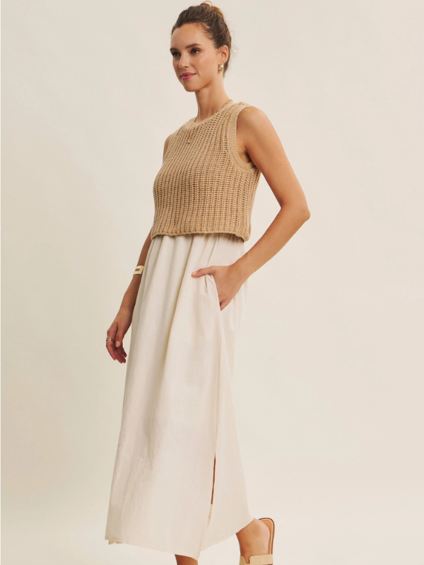 Woman wearing a beige sleeveless top and white skirt on a plain background