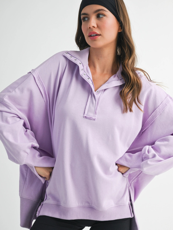 Woman wearing a light purple pullover with a white background