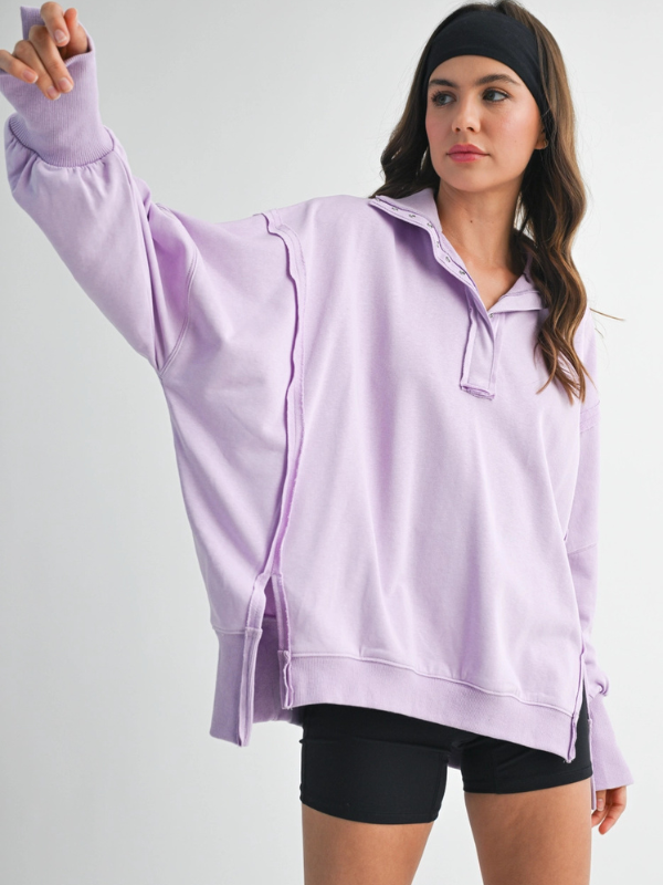 Woman wearing a light purple hoodie and black shorts on a white background