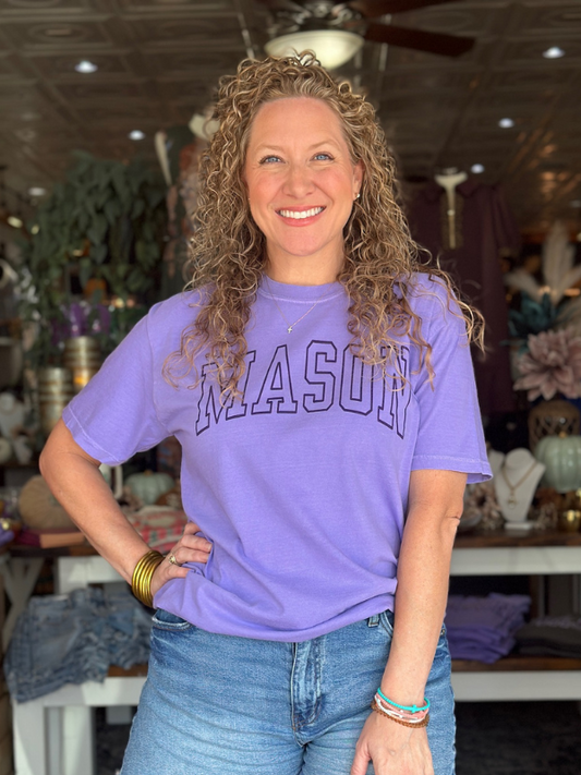 Woman wearing a purple 'MASON' t-shirt in a store setting