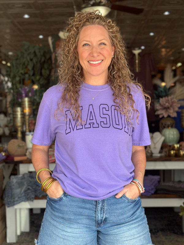 Woman wearing a purple 'MASON' t-shirt in a store setting