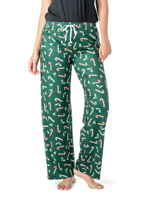 Green pajama pants with candy cane pattern worn by a person on a white background