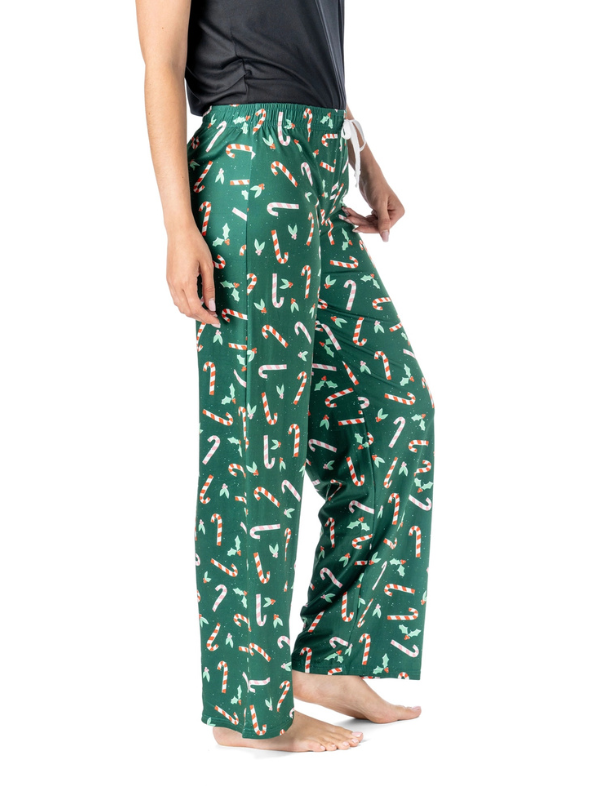 Green pajama pants with candy cane pattern worn by a person on a white background