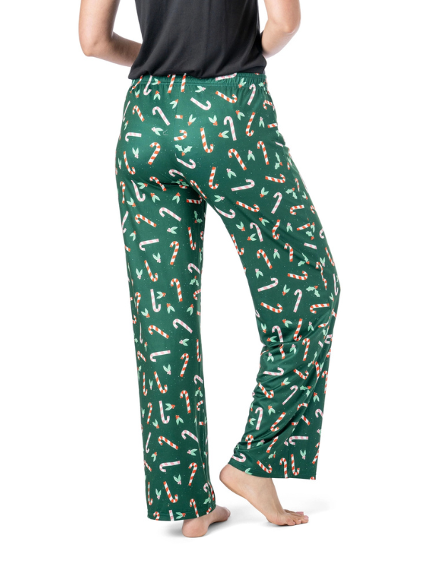 Green pants with candy cane pattern worn by a person on a white background