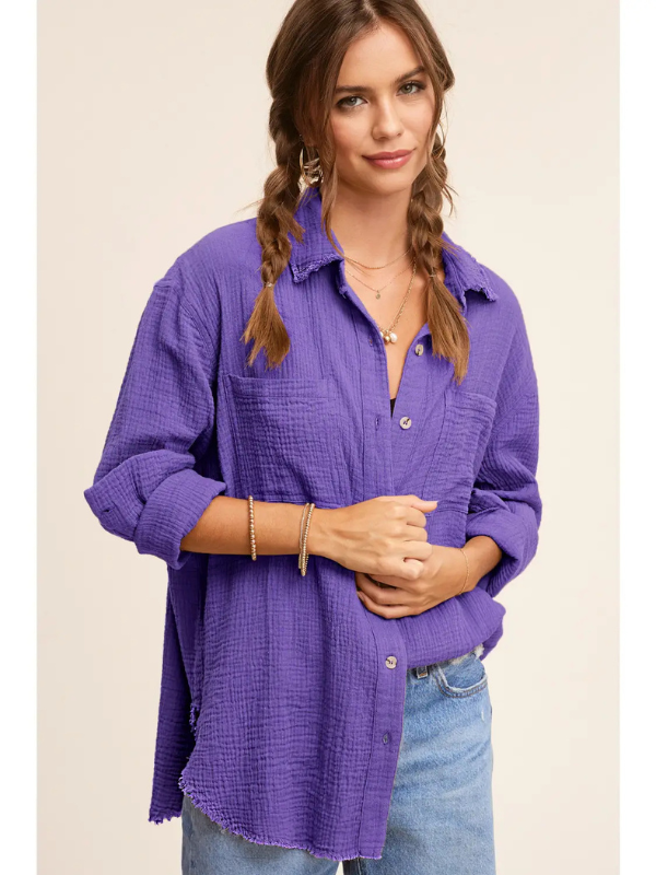 Woman wearing a purple textured shirt with a beige background