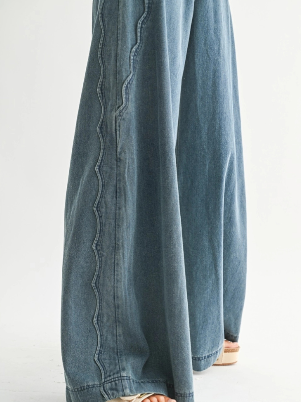 Blue denim pants with a white background