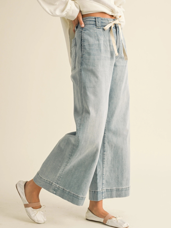 Light blue denim wide-leg pants with a white background