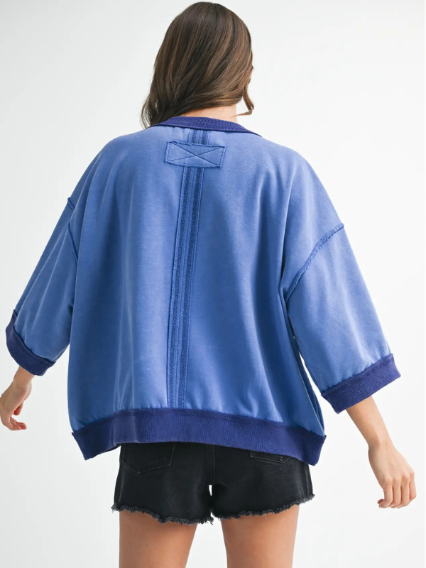 Person wearing a blue kimono-style garment on a white background