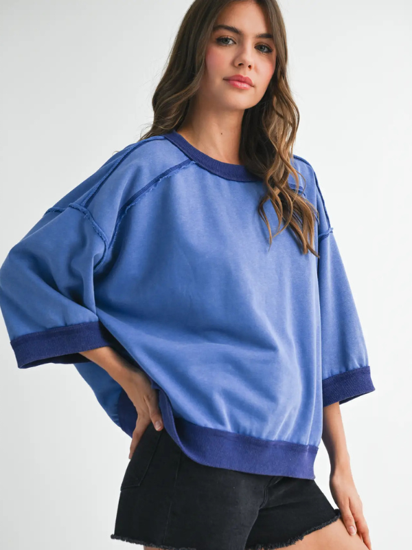 Woman wearing a blue sweater with a white background