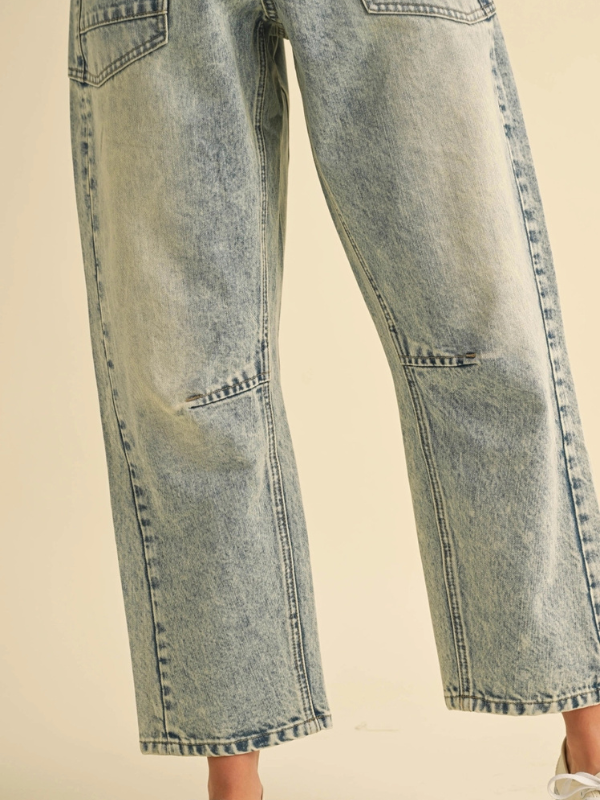 Light blue denim jeans on a beige background