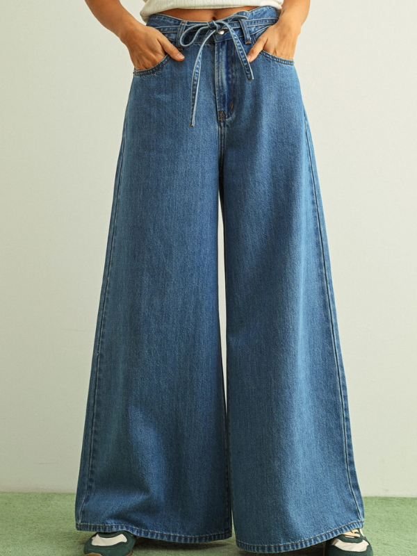 Wide-leg jeans worn by a person on a plain background