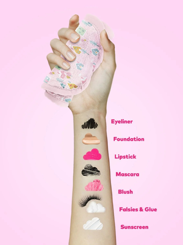 Hand with makeup product and labeled makeup items on a pink background