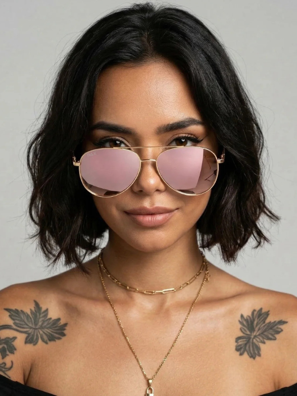 Woman wearing pink sunglasses with a neutral background